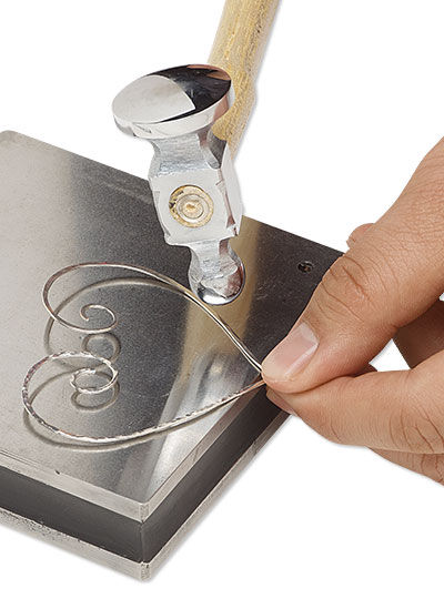 Hammer striking wire on a steel block